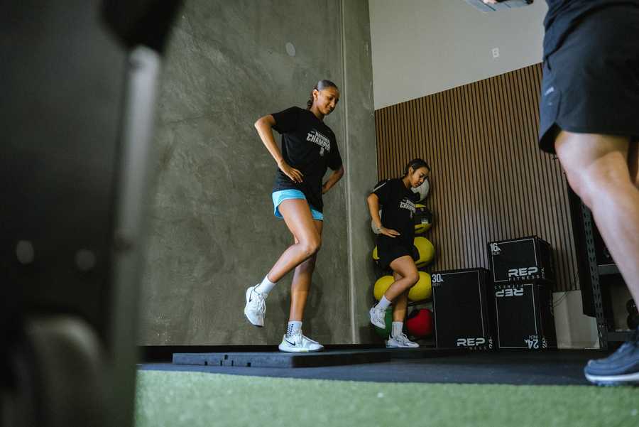 Coach working one-on-one with a youth athlete in San Diego
