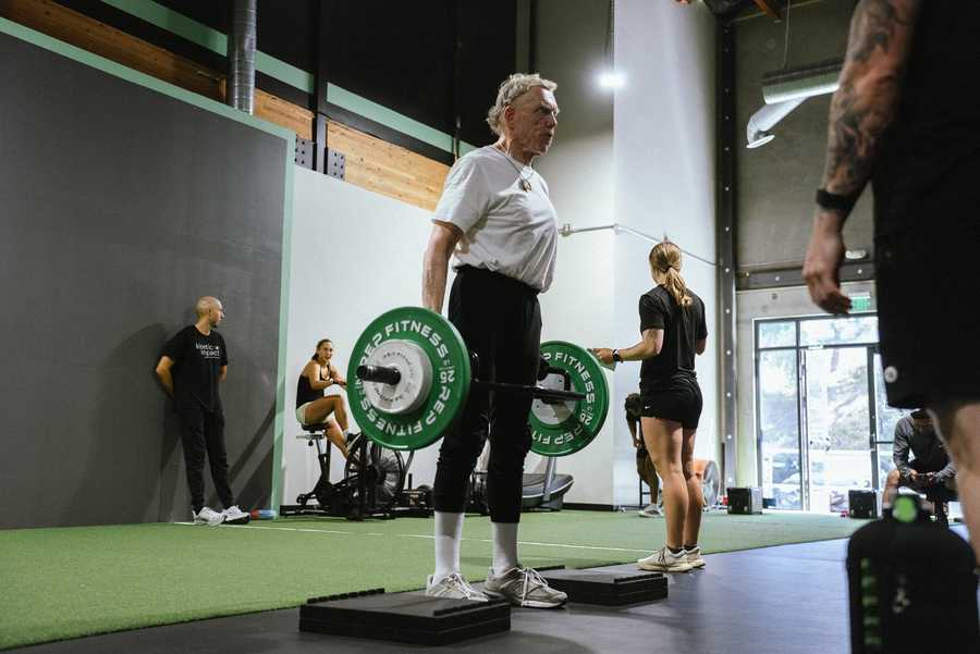 Adults strength training session at Kinetic Impact in San Diego