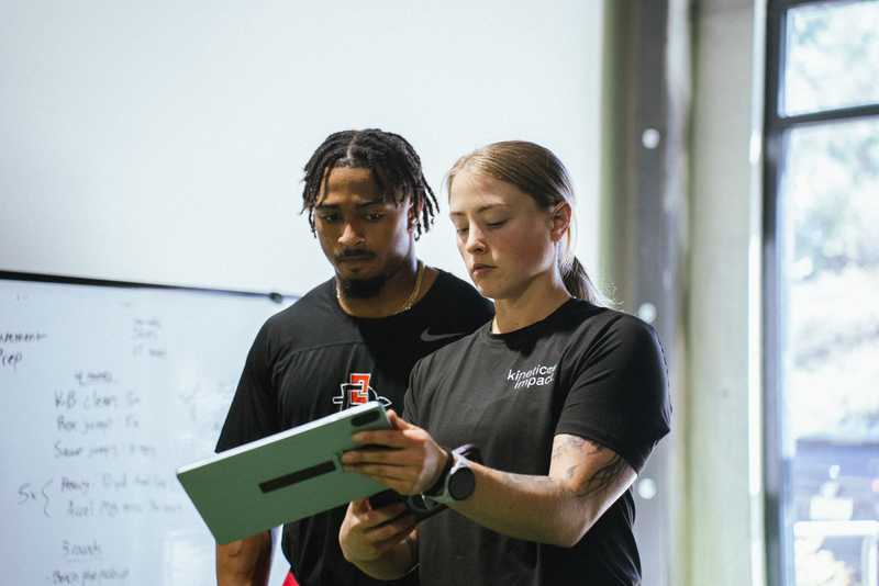 Coach reviewing a personalized training program with an athlete in San Diego
